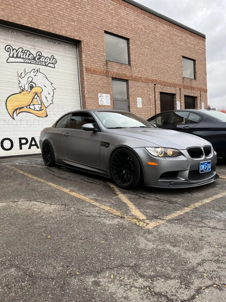 Grey BMW convertible parked outside the White Eagle Motors shop