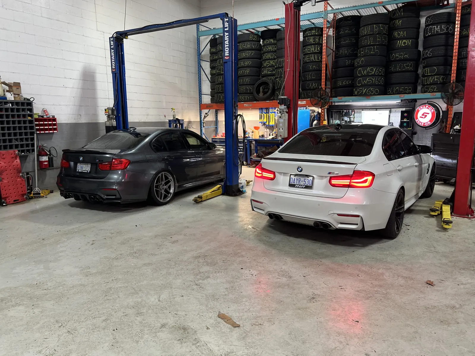 Two BMWs in the White Eagle Motors service bay in Mississauga